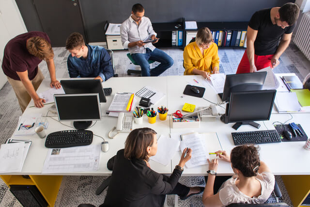 Hiring IT Developers in Poland in 2024 3 People working in office